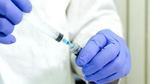 Scientific using a syringe in a laboratory. Selective focus Stock Photos