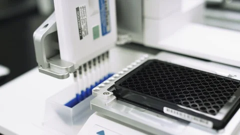 Scientifically measuring blue liquid to test samples for virus in a lab Stock Footage 127533260
