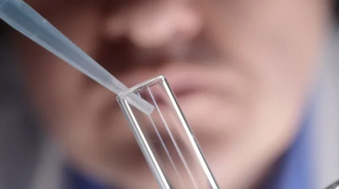 Scientist adding chemicals to test tube Stock Footage 35109189