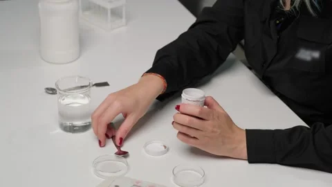 Scientist Adding Powder to Liquid in Laboratory Stock Footage 303369298