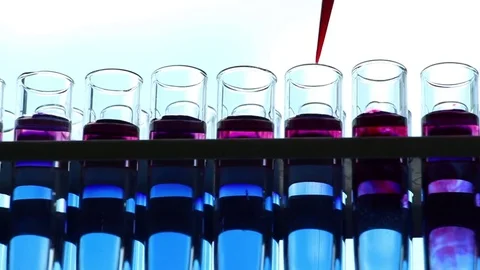 Scientist adds reagents into  vials on sky background dolly shot Stock-Footage 77209000