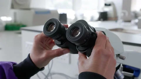 Scientist adjusting microscope diopter eyepieces Stock Footage 232008393