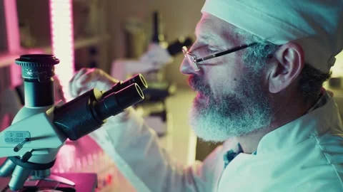 Scientist adjusting microscope in laboratory 스톡 동영상 306594443