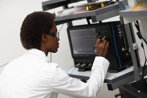 Scientist african american woman working in laboratory with electronic Stock Photos