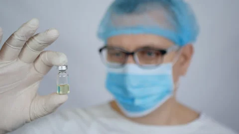 A scientist with an ampoule in his hand, the development of new drugs Stock Footage 106157508