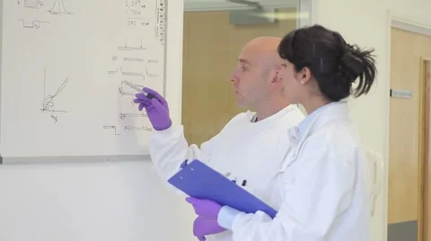 Scientist analyze and discuss research data on white board in science laboratory Stock Footage 5113147