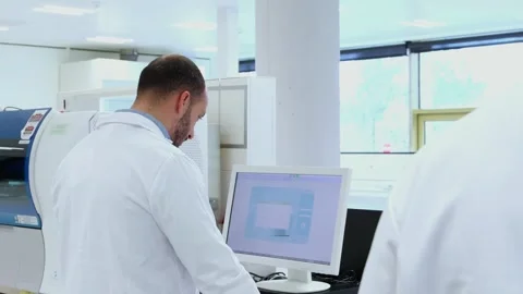 Scientist analyzing data on computer in modern laboratory Stock-Footage 296886137
