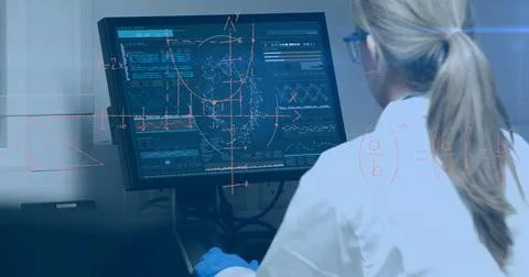 Scientist analyzing data on computer screen in laboratory, focused on research 写真素材