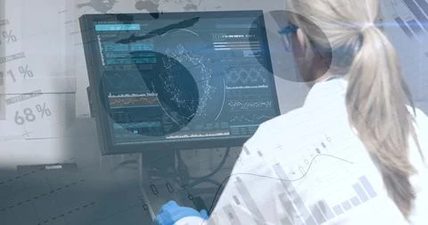 Scientist analyzing data on computer screen in laboratory, focused on research 스톡 사진