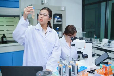 Scientist Analyzing Sample in Laboratory with Microscope Stock Photos