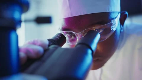 Scientist analyzing sample with microscope in laboratory Stock Footage 306588632