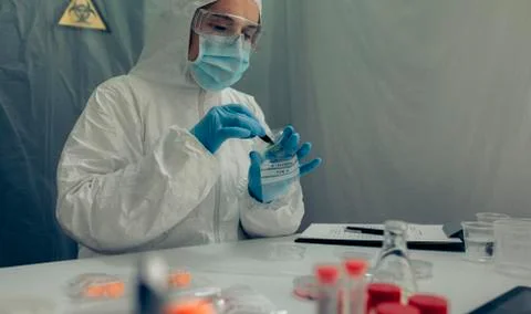 Scientist analyzing samples contaminated with virus Stock Photos