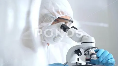 Scientist is analyzing samples using a microscope in a laboratory setting. Close Fotos de archivo