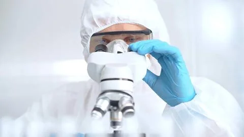 Scientist is analyzing samples using a microscope in a laboratory setting. Close Foto stock