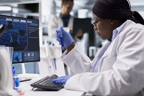 Scientist analyzing tissue in flasks for a bio science study Stock Photos