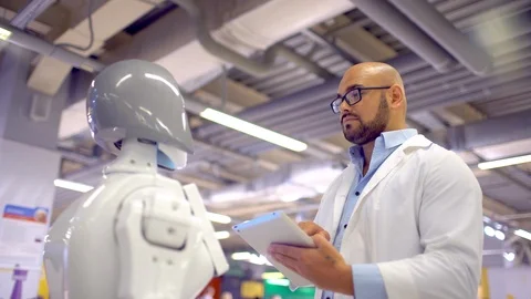 A scientist and a robot. High technologies and robots Stock Footage 86445255