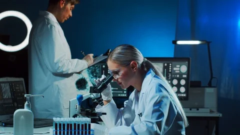 Scientist and student working in lab. Doctor teaching intern to make blood Stock Footage 127211764