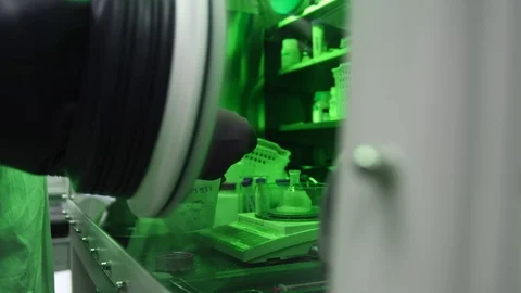 Scientist arms working in lab vacuum box for research of biological substances Stock Footage 104583242