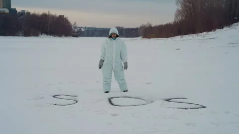 Scientist attentively analyzes icy wilderness silently for discoveries. Silent Stock Footage 346471633