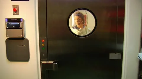 Scientist in bubble suit exits airlock Stock Footage 21532726