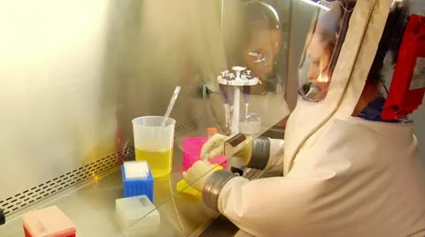 Scientist in bubble suit uses pipette to transfer samples 스톡 동영상 21533079