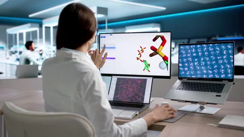 Scientist Carefully Analyzes Protein Samples Using Computer Stock Footage 334927428