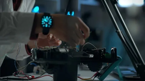 A scientist carefully assembles electronic components in a modern laboratory Stock Footage 289576366