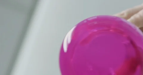 Scientist changes coloured water to clear water by stirring Stock Footage 104821644