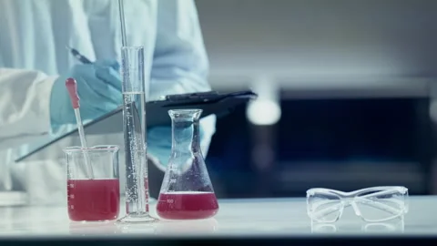Scientist checking liquids in laboratory Stock Footage 149246470
