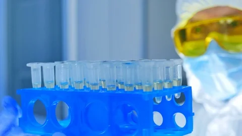 Scientist checking materials in test tubes in laboratory. People with medical Stock Footage 108471589