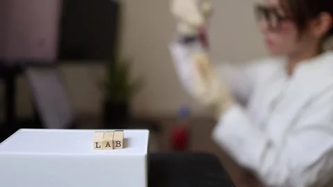 Scientist checks sample in test tube Vidéo 337571420