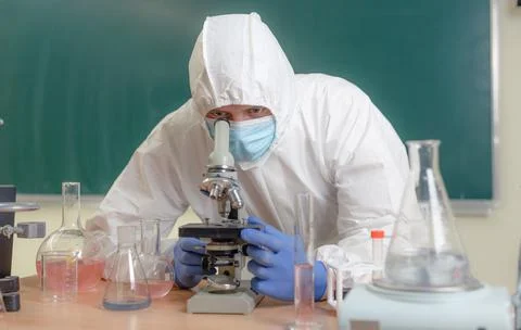 A scientist chemist in the laboratory conducts a study of viruses carefully Stock Photos