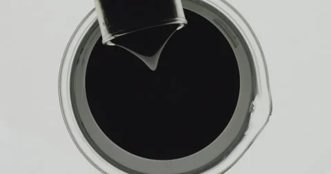 Scientist chemist pouring used engine oil from glass into beaker., Top view Stock Footage 271252806