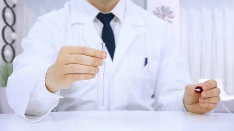 Scientist chemist working at a laboratory experiments Stock Footage 109382934