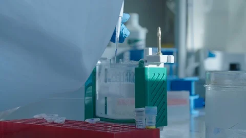 Scientist collecting  sample in test tube and injecting it in plastic container Stock Footage 104247338