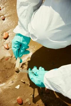 Scientist Collecting Sand Sample for Environmental Analysis Stock Photos