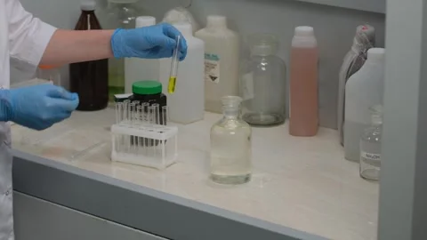 Scientist Conducting Laboratory Experiment with Test Tubes Stock Footage 303369421
