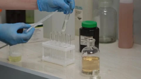 Scientist Conducting Laboratory Experiment with Test Tubes Stock Footage 303369592