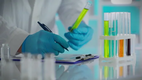 A scientist is conducting research in a laboratory, where his attention is d Stock Footage 263921705