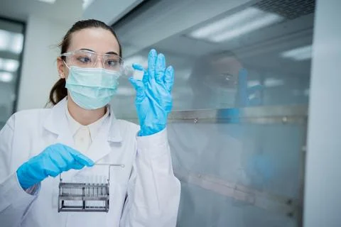Scientist conducts experiment in laboratory while wearing protective gear a.. Fotos de archivo