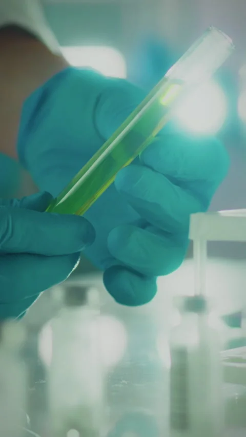 Scientist conducts an experiment using a green liquid in a laboratory settin Stock Footage 331725506
