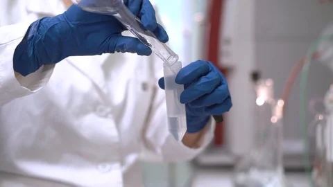 Scientist conducts experiments, stirs the liquid reagent, pours into a test tube Stock Footage 115101574