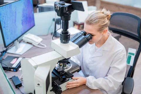 Scientist conducts research using a microscope in a laboratory setting duri.. Stock Photos