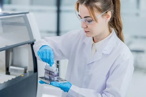 Scientist conducts tests in a laboratory using equipment and samples during.. Фото