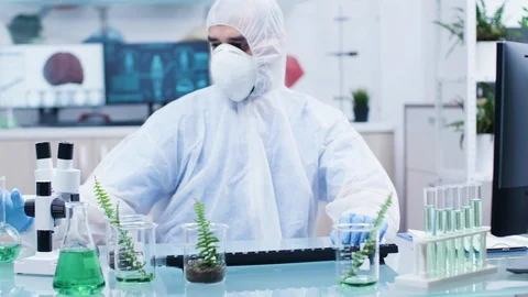 Scientist in coverall analyzing different samples Stock Footage 113673107