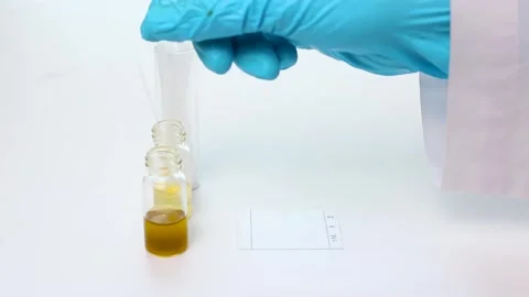 Scientist Dipping Capillary Tube into Sample Vial and Spotting on TLC Plate Stock Footage 323139392