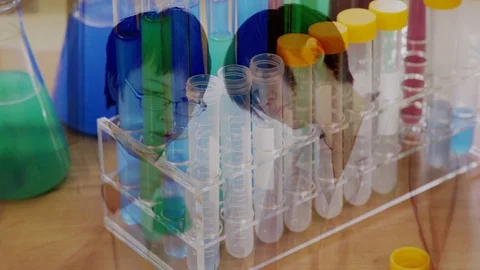 Scientist discuss with multiple exposure with test tubes and sample tubes Stock Footage 105855384