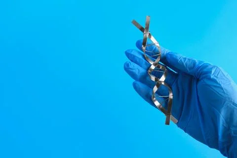 Scientist with DNA molecular chain model made of metal on blue background, .. 写真素材