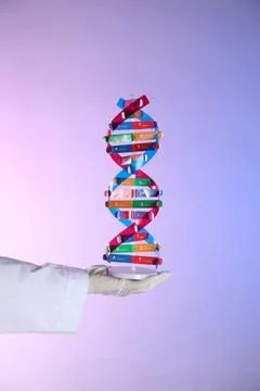 Scientist with DNA structure model on color background, closeup 写真素材