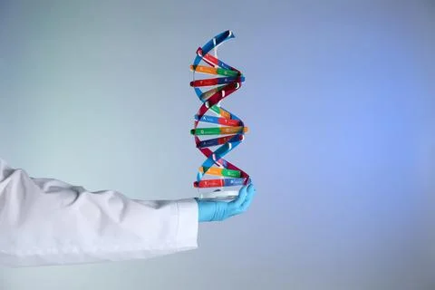 Scientist with DNA structure model on color background, closeup Stock Photos